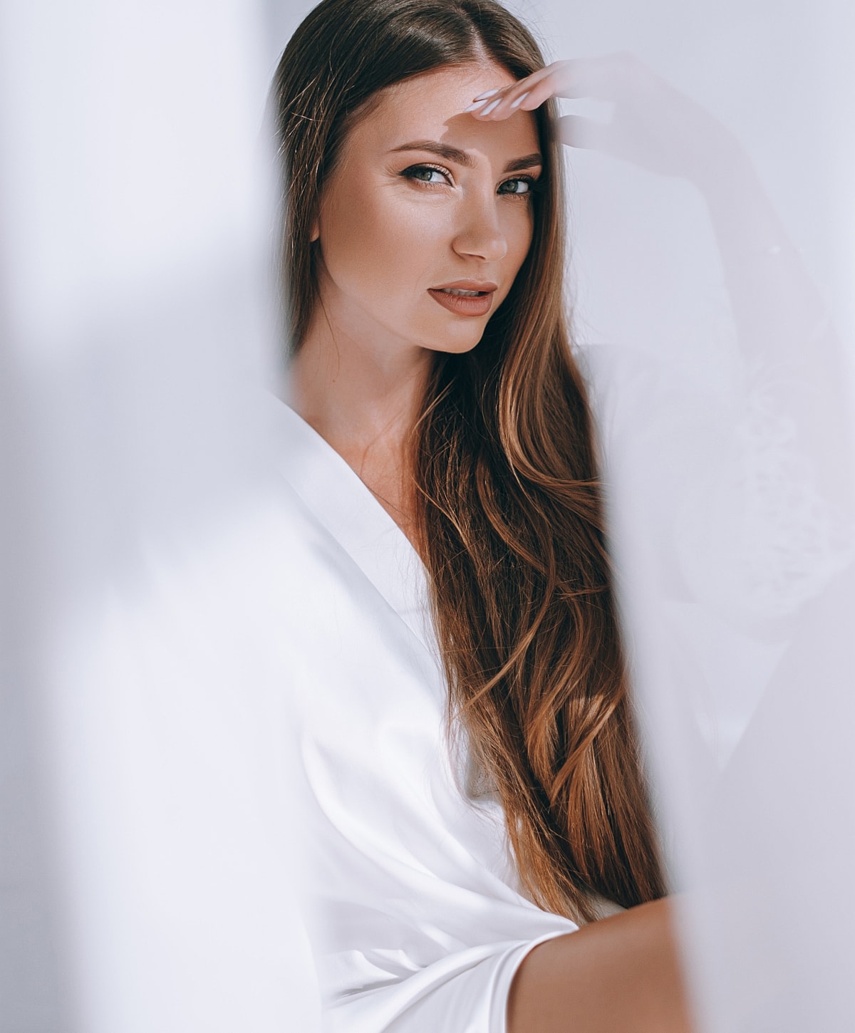 Woman with long hair in soft natural light.