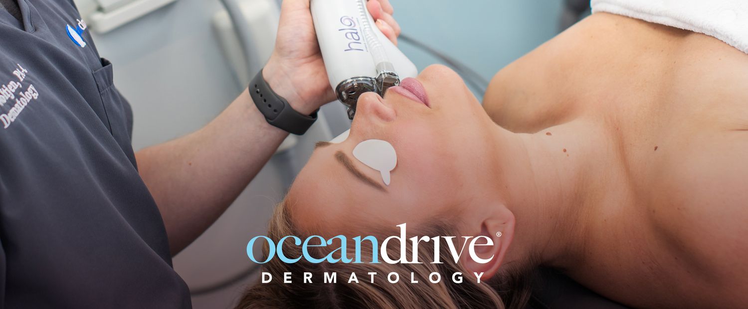 Woman relaxing by a pool surrounded by greenery.