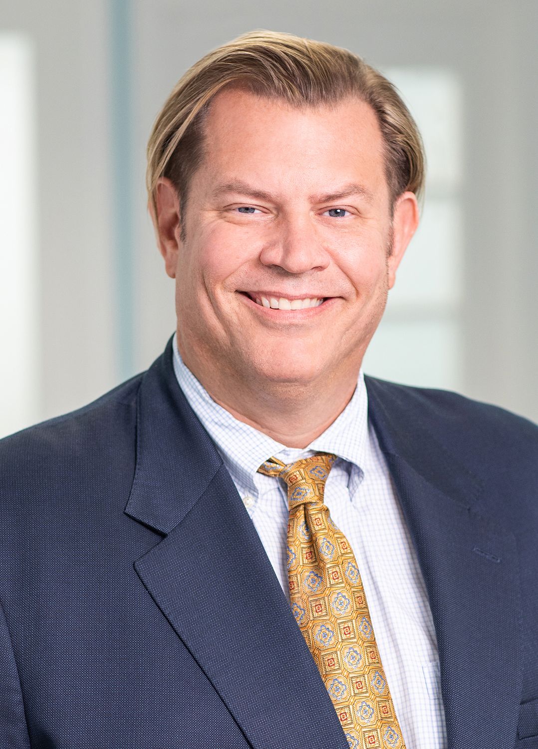 Man standing by the pool in sunlight.