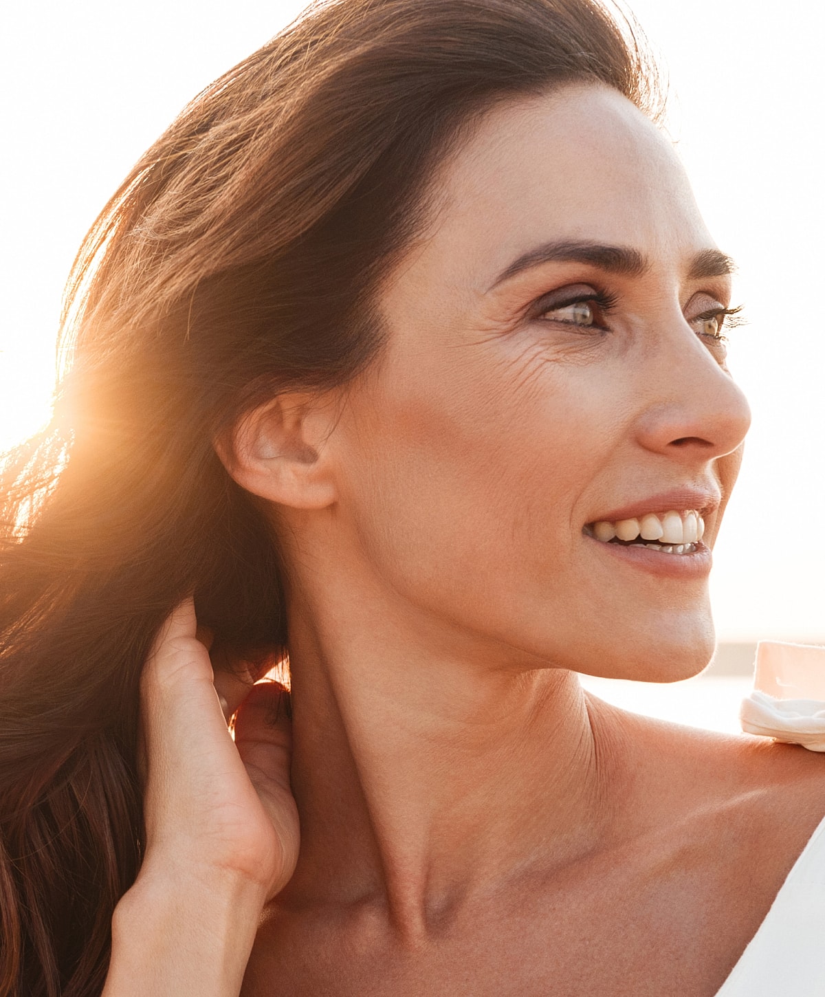 Profile portrait of woman with hoop earrings.