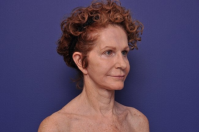 Profile portrait of woman with curly hair.