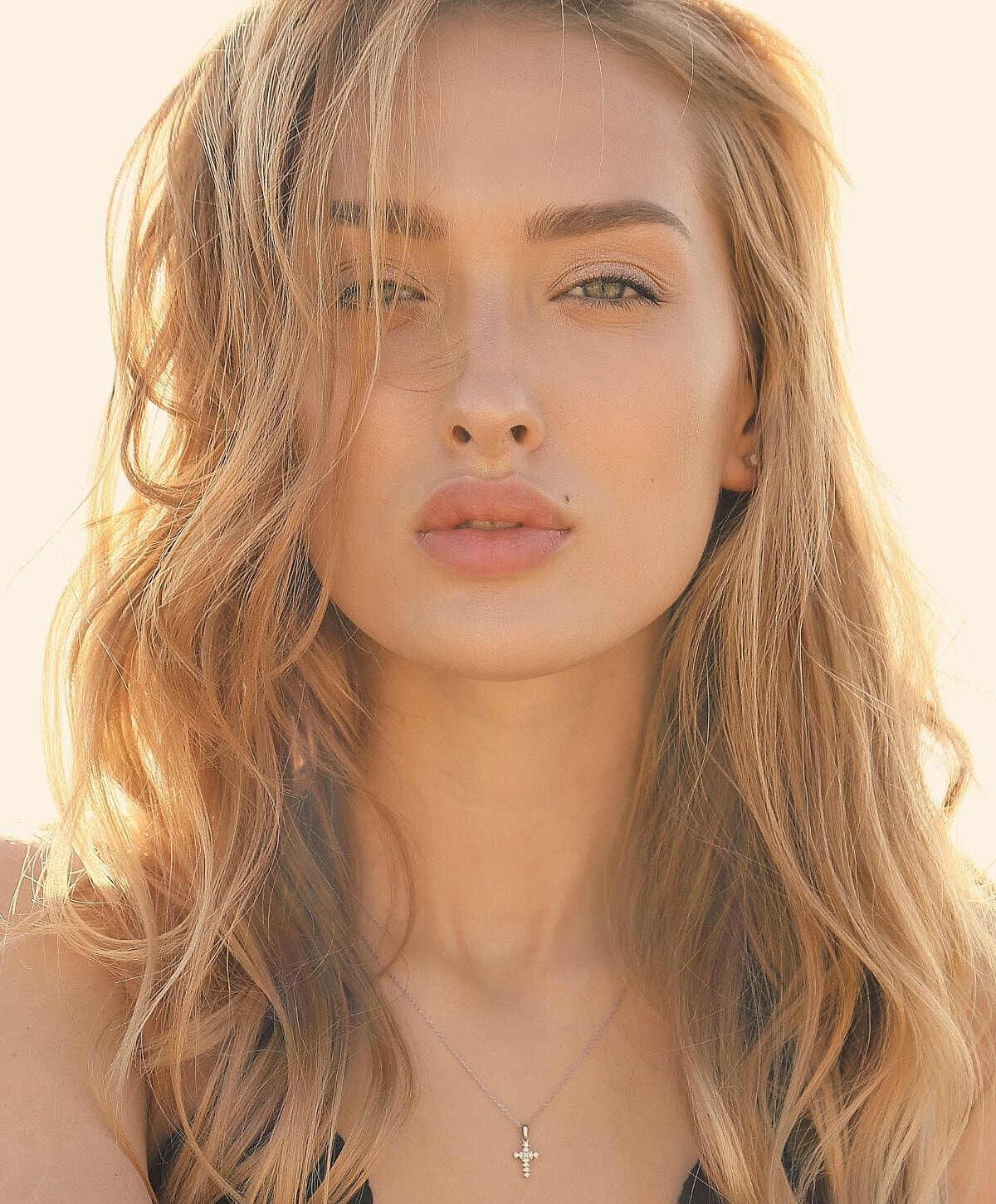Portrait of a woman with wavy blonde hair.