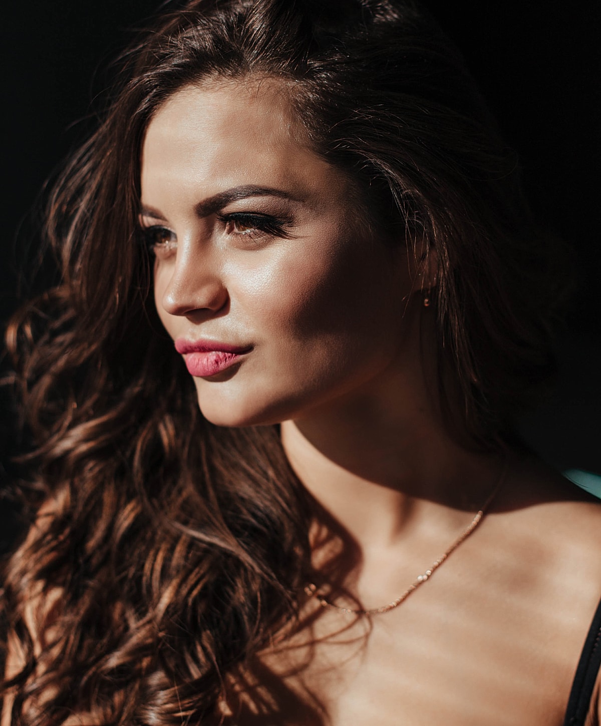 Profile of a woman with wavy hair.