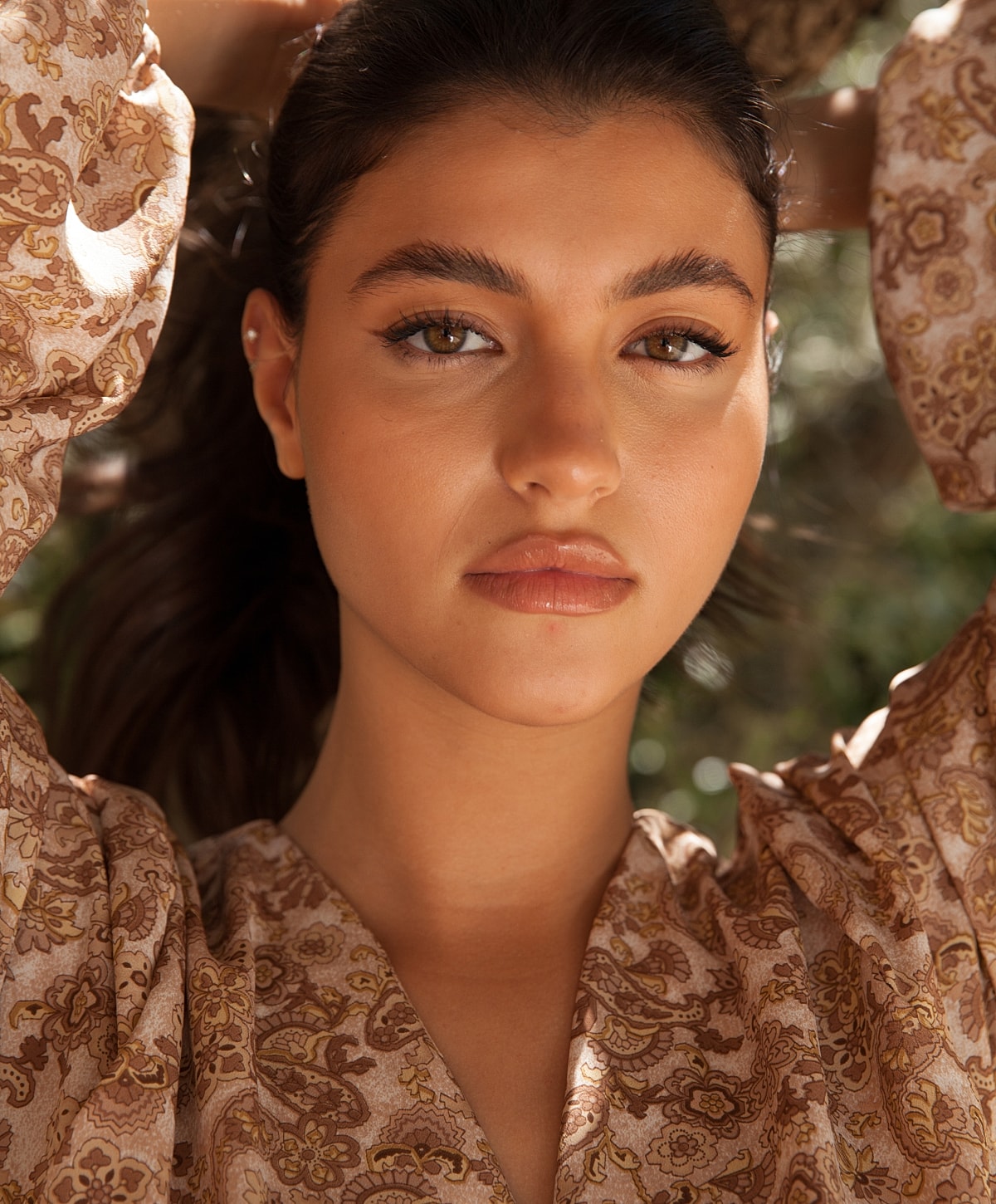 Portrait of a woman with wavy brown hair.