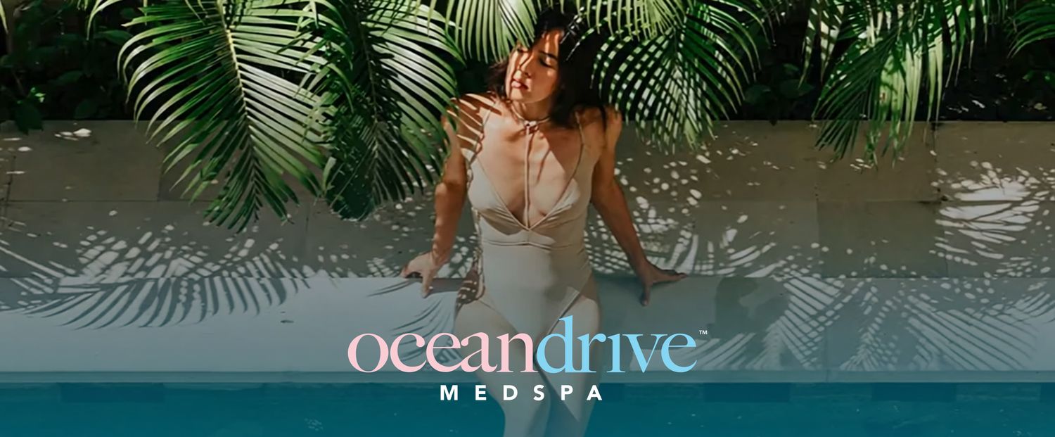 Woman relaxing by a pool surrounded by greenery.