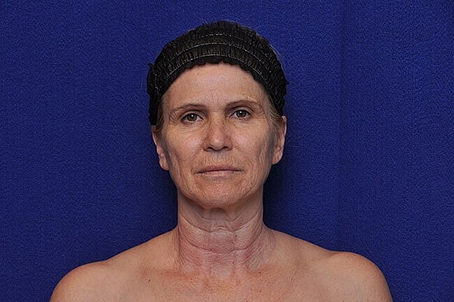 Middle-aged woman with a dark hair accessory.