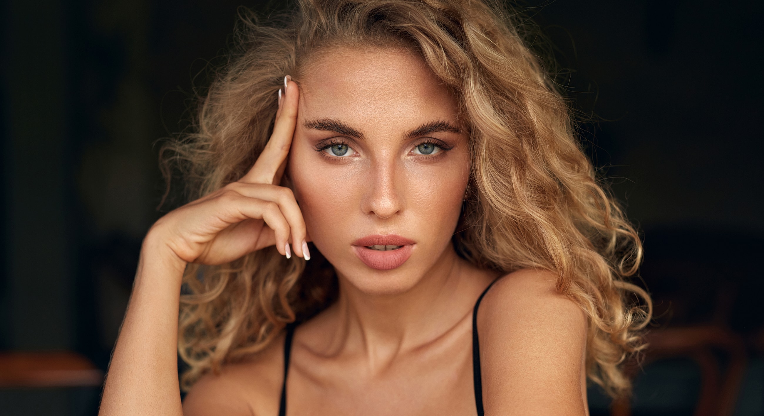 Close-up of a woman resting her head.